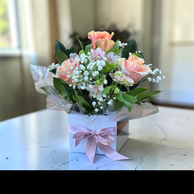 Amanda - Roses, Alstroemerias, Babies Breath and foliage
arranged in a white box.
Perfect for Sympathies, funerals, and just because.